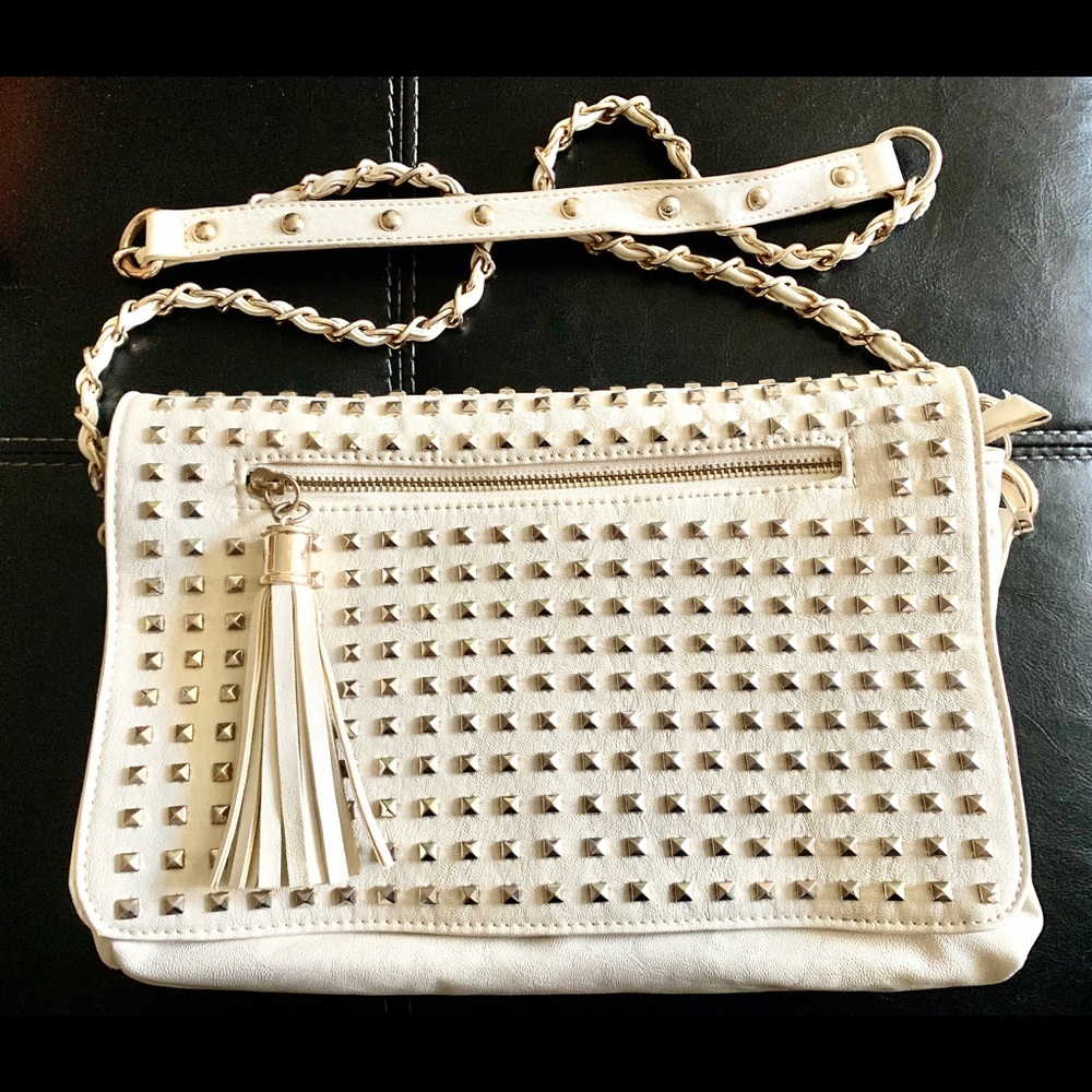 Cream and gold-studded shoulder bag.